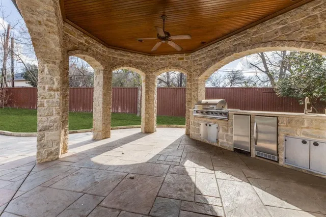 a view of a patio with table and chairs a barbeque with wooden fence
