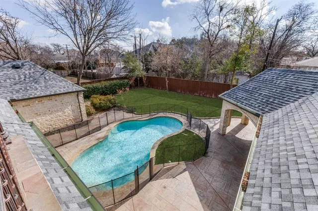 a view of backyard with swimming pool and outdoor seating