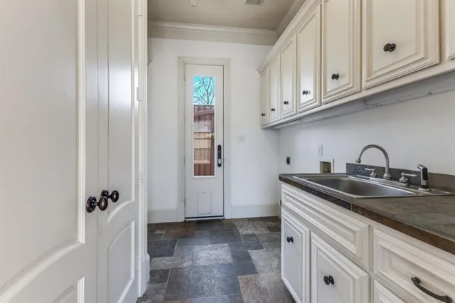 a kitchen with stainless steel appliances granite countertop a sink and cabinets