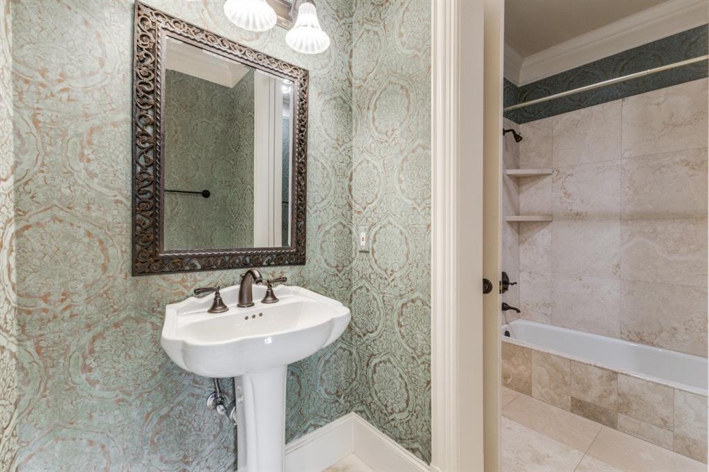 6416 Dykes Way Dallas, TX 75230 - Photo 18 of 37 a bathroom with a sink and a mirror