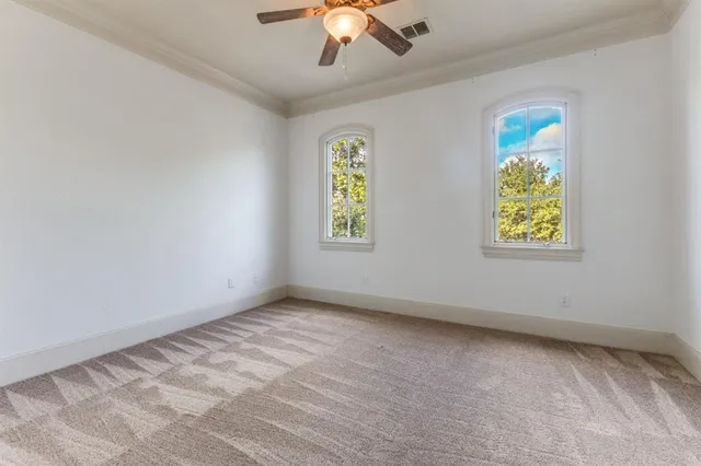 a view of room with window and ceiling fan