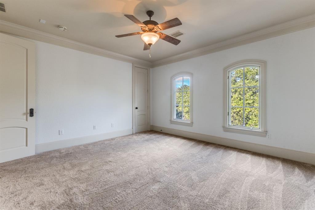 6416 Dykes Way Dallas, TX 75230 - Photo 21 of 37 an empty room with windows and fan