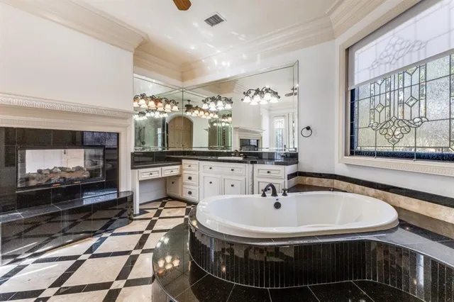 a bathroom with a sink a large mirror and a glass door shower