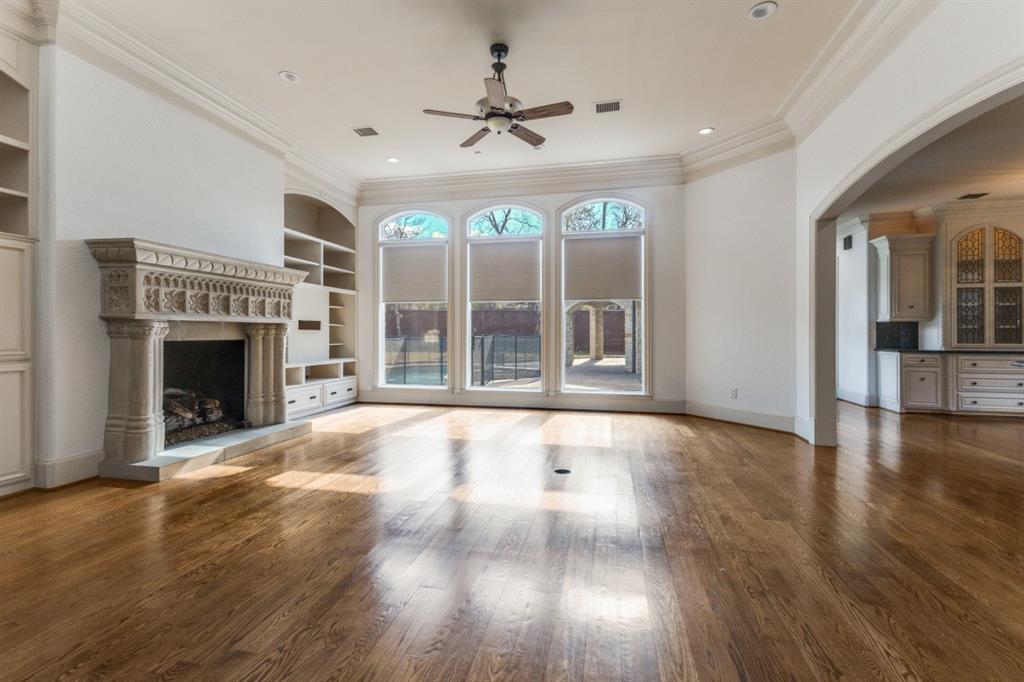 6416 Dykes Way Dallas, TX 75230 - Photo 34 of 37 an empty room with floor fireplace and windows