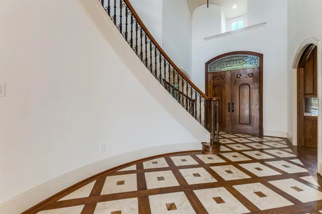 a view of staircase with lots of frames on wall and a window