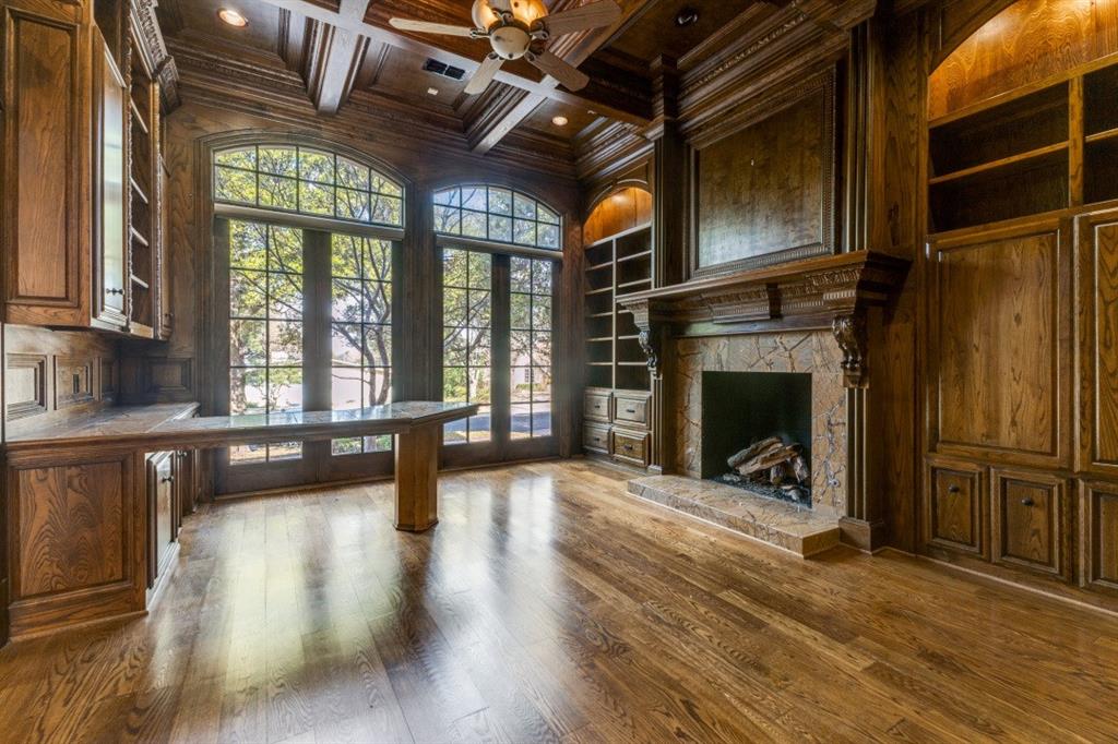 6416 Dykes Way Dallas, TX 75230 - Photo 8 of 37 a view of an empty room with wooden floor and a fireplace