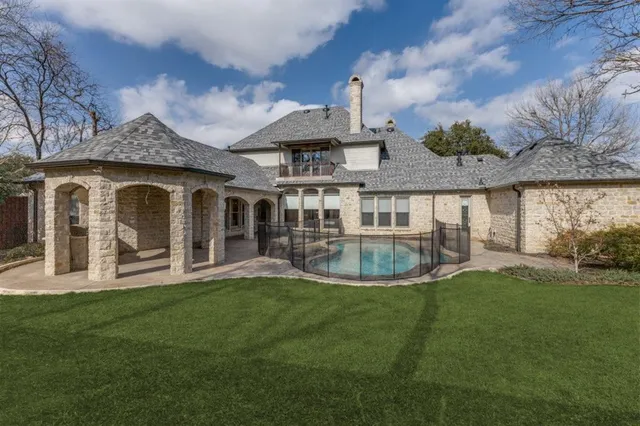 a view of a house with a yard and sitting area