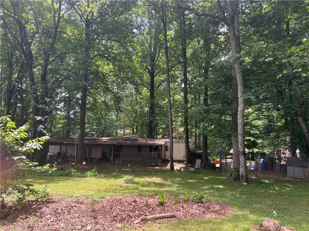 a view of a backyard with swimming pool