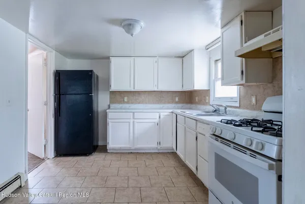 a kitchen with a stove and a refrigerator