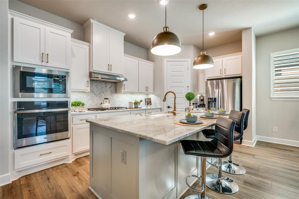 6333 Hedgecoxe Road The Colony, TX 75056 - Photo 7 of 25 Lovely white kitchen and Island for entertaining
