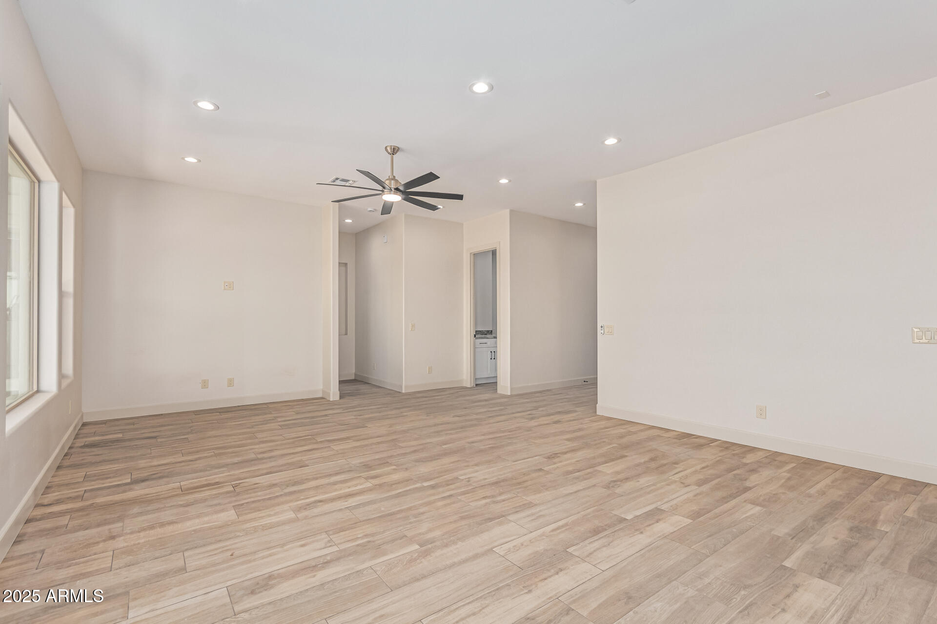 14730 South Rory Calhoun Road Arizona City, AZ 85123 - Photo 12 of 43 a view of an empty room with wooden floor and a window