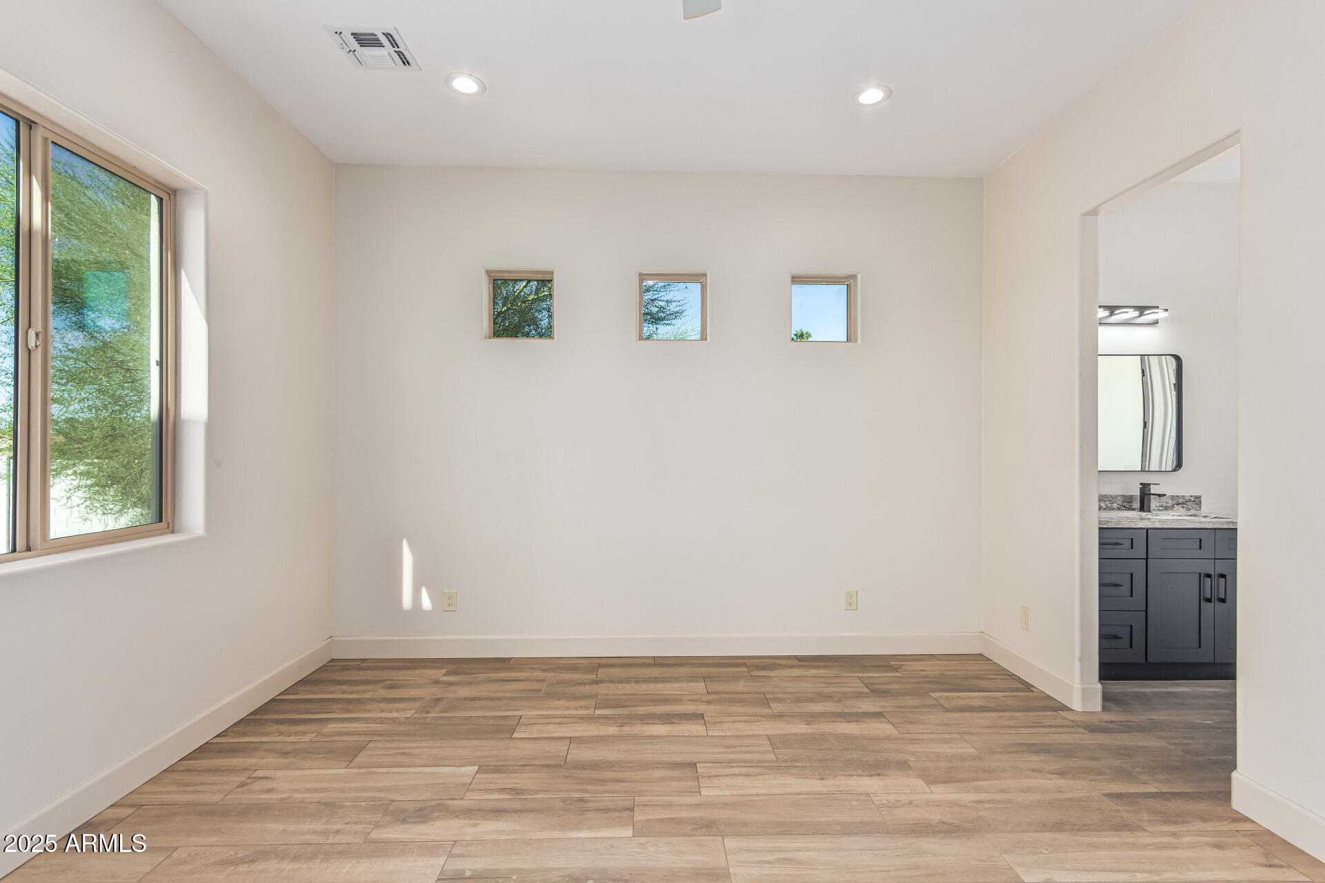 14730 South Rory Calhoun Road Arizona City, AZ 85123 - Photo 14 of 43 an empty room with wooden floor and windows