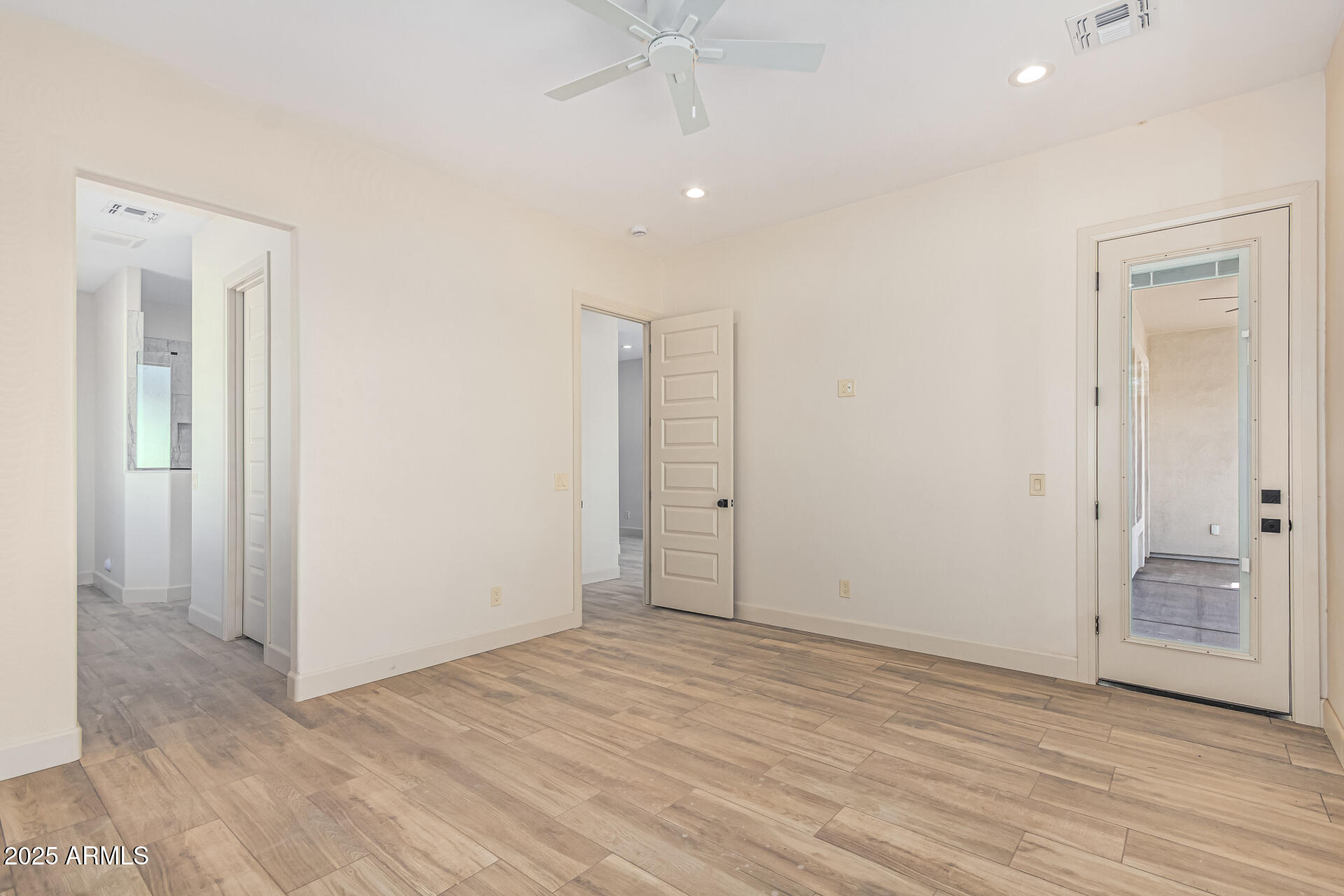 14730 South Rory Calhoun Road Arizona City, AZ 85123 - Photo 16 of 43 an empty room with wooden floor and a ceiling fan