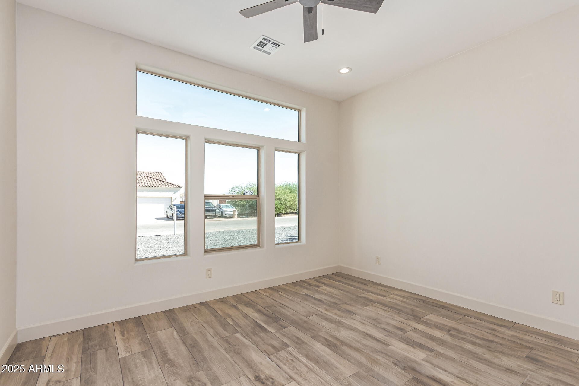 14730 South Rory Calhoun Road Arizona City, AZ 85123 - Photo 20 of 43 an empty room with wooden floor chandelier and windows