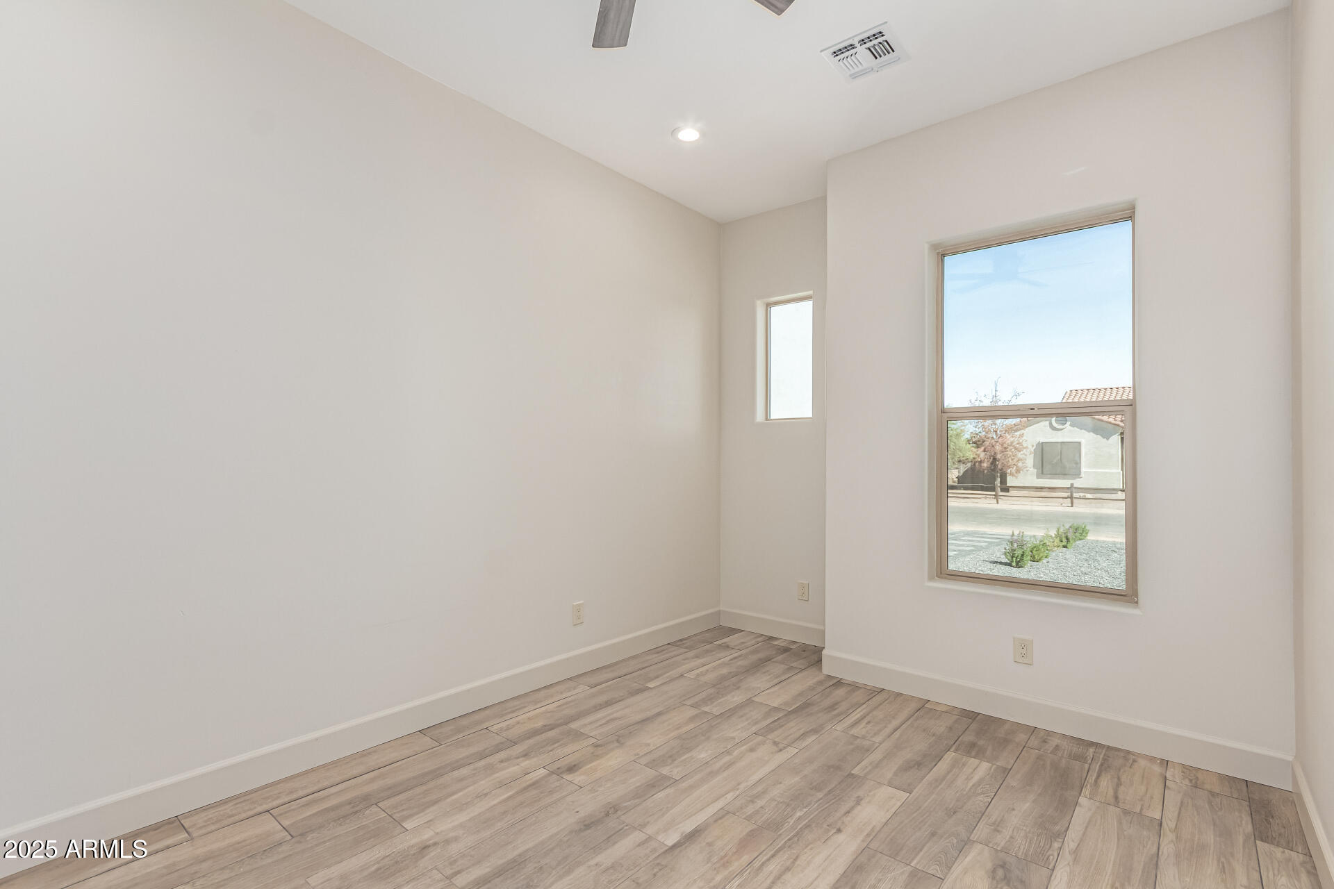 14730 South Rory Calhoun Road Arizona City, AZ 85123 - Photo 22 of 43 an empty room with wooden floor and windows