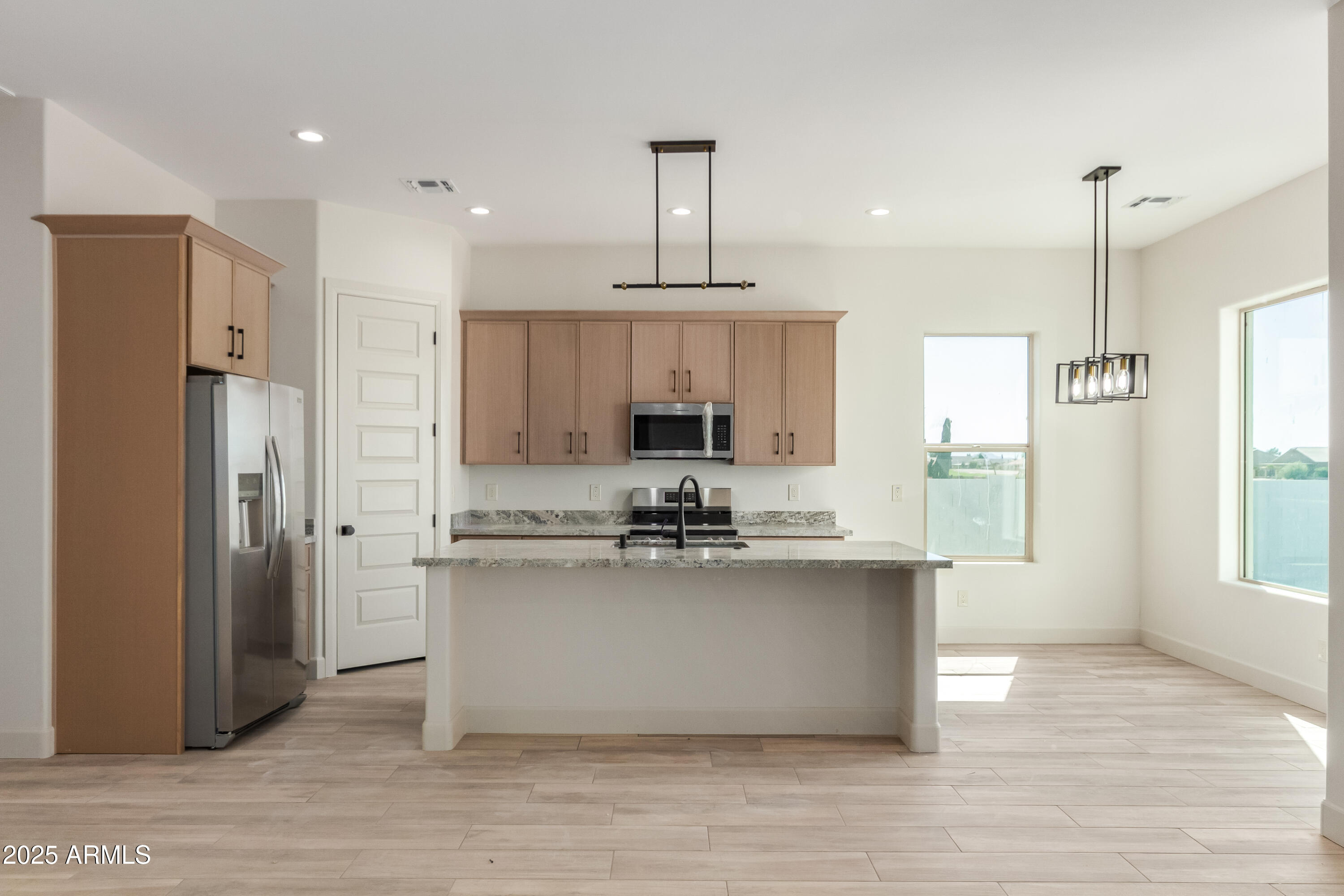 14730 South Rory Calhoun Road Arizona City, AZ 85123 - Photo 5 of 43 a view of a kitchen with kitchen island a counter top space stainless steel appliances and a window