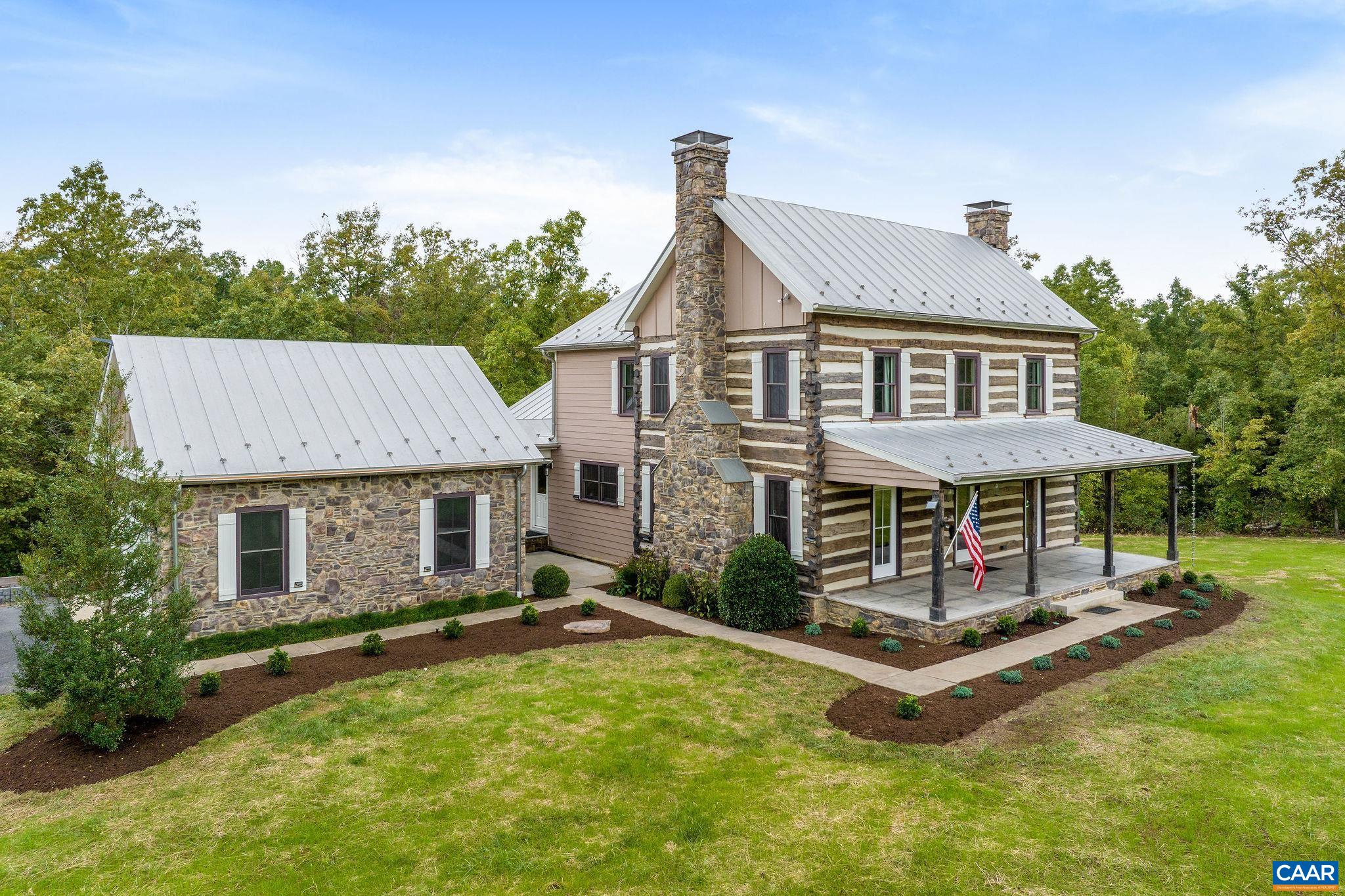 a view of a house with a backyard porch and sitting area