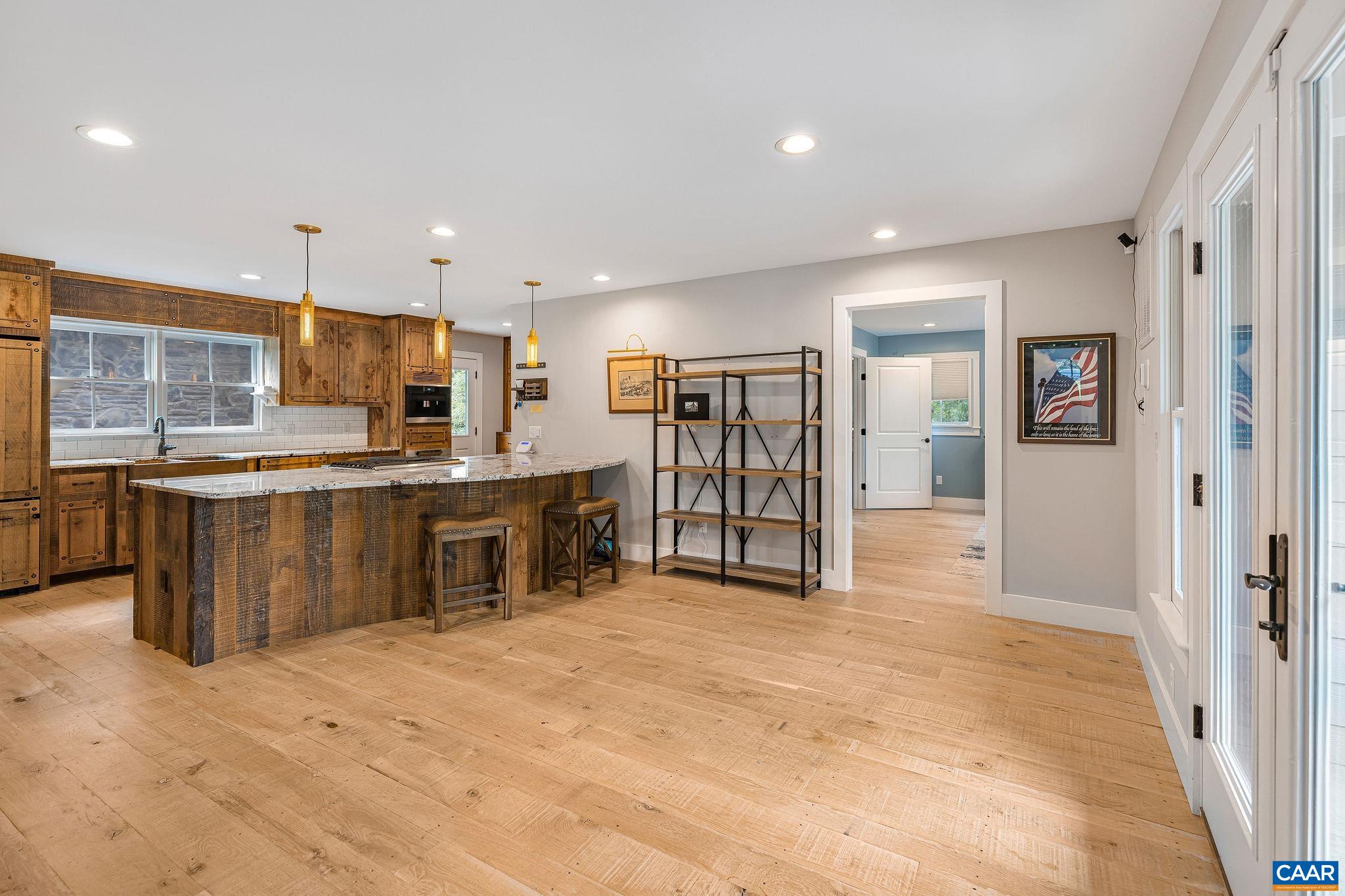 5620 Blenheim Road Charlottesville, VA 22902 - Photo 16 of 59 a open kitchen with stainless steel appliances kitchen island granite countertop a stove and a sink