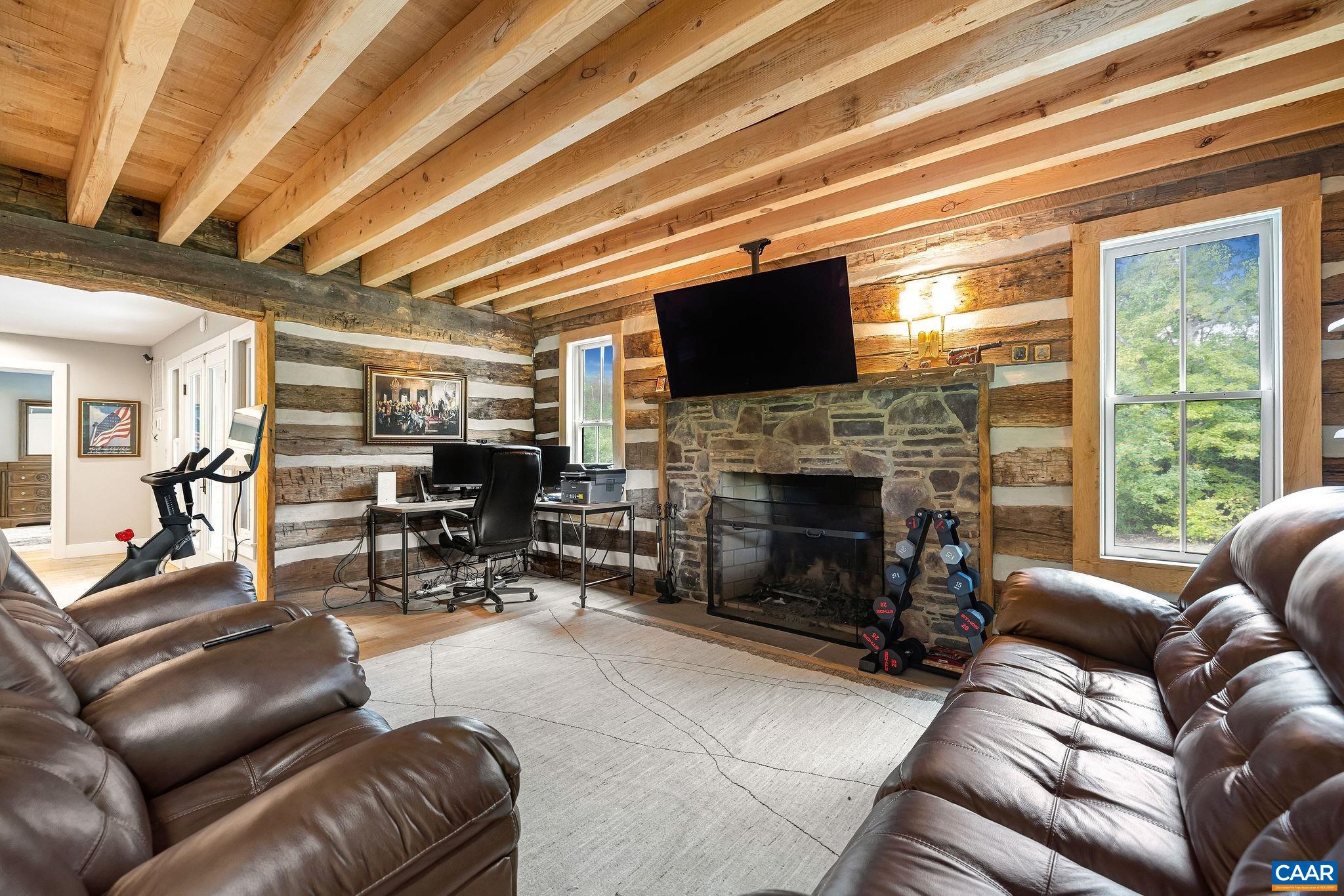 5620 Blenheim Road Charlottesville, VA 22902 - Photo 18 of 59 a living room with furniture a fireplace and a flat screen tv