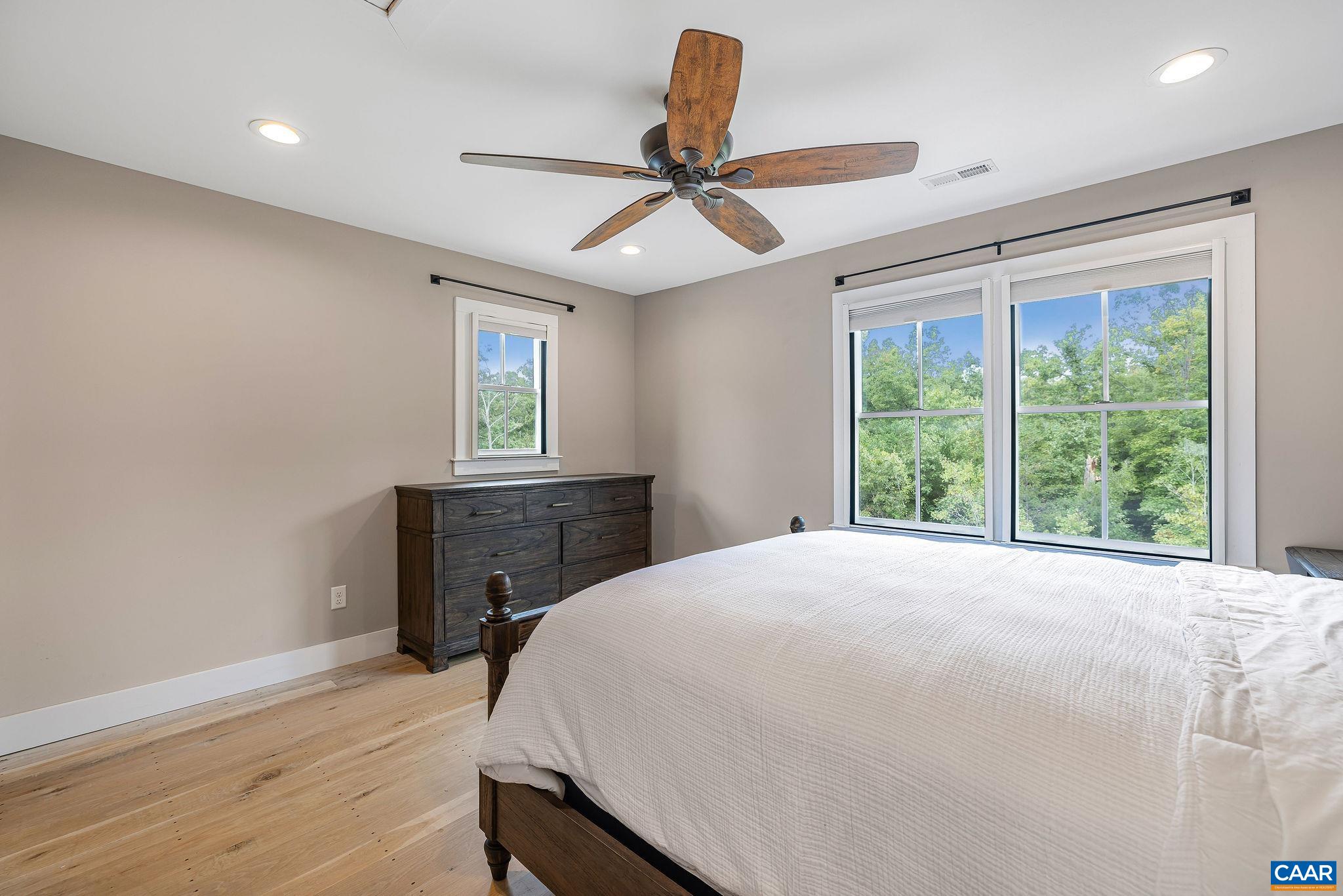 5620 Blenheim Road Charlottesville, VA 22902 - Photo 30 of 59 a bedroom with a bed and a chandelier
