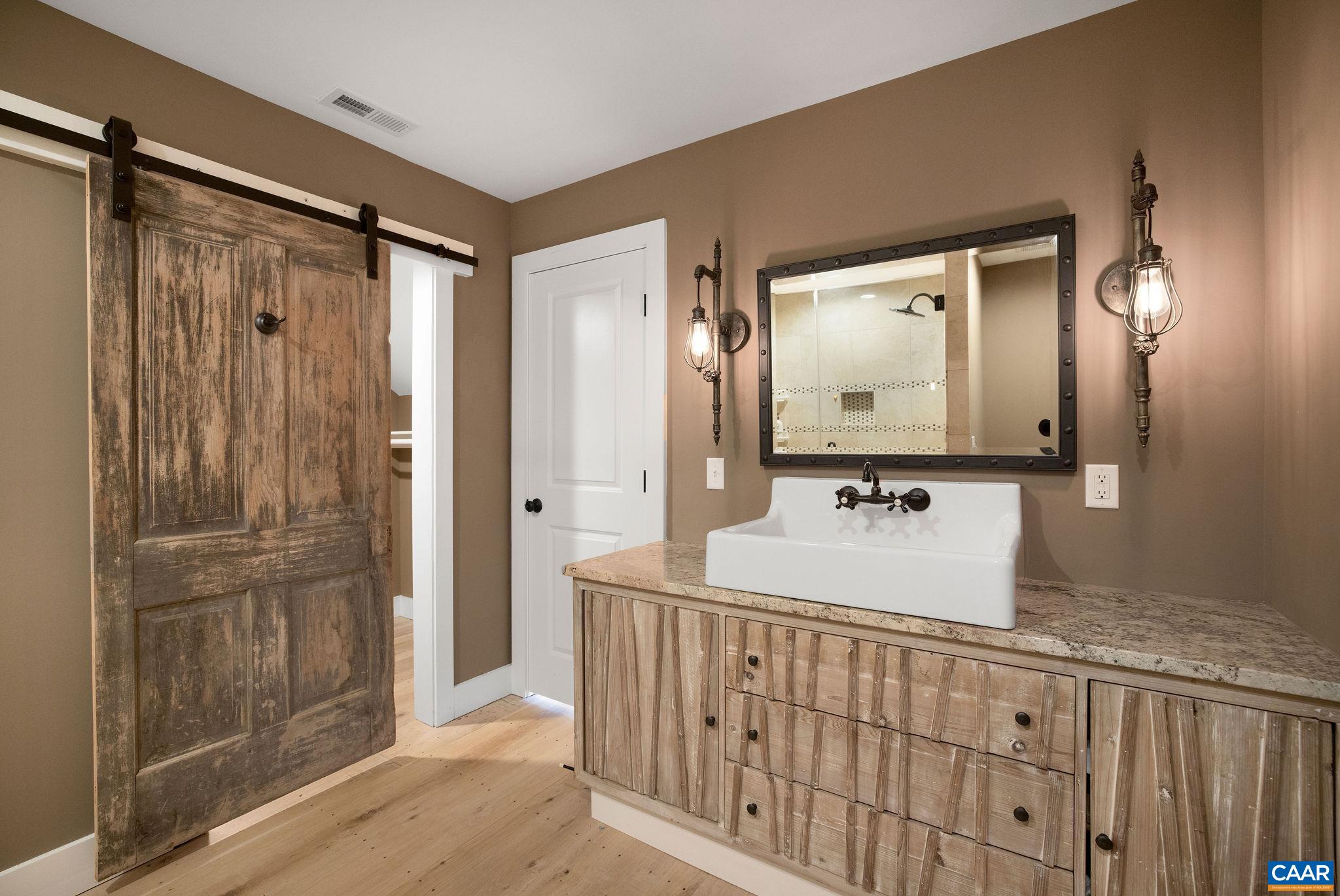 5620 Blenheim Road Charlottesville, VA 22902 - Photo 32 of 59 a bathroom with a sink a mirror and shower