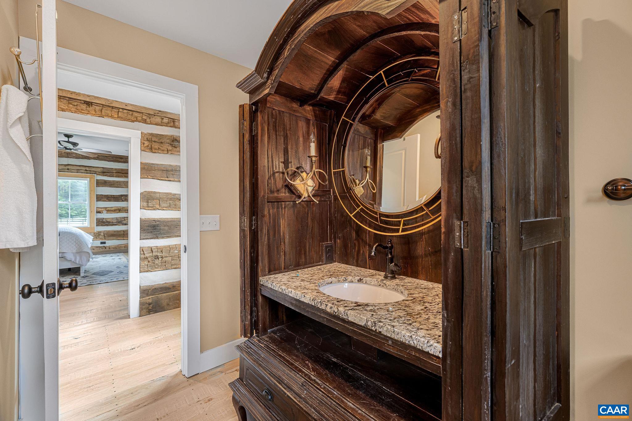 5620 Blenheim Road Charlottesville, VA 22902 - Photo 35 of 59 a bathroom with a granite countertop sink a mirror and a shower