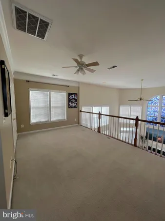 a view of a livingroom with a ceiling fan and window