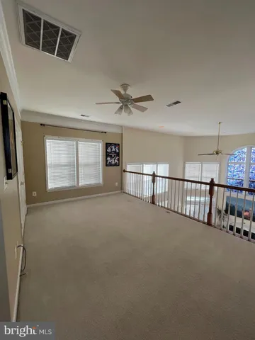 a view of a livingroom with a ceiling fan and window