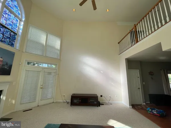 a view of a livingroom with furniture and a floor to ceiling window