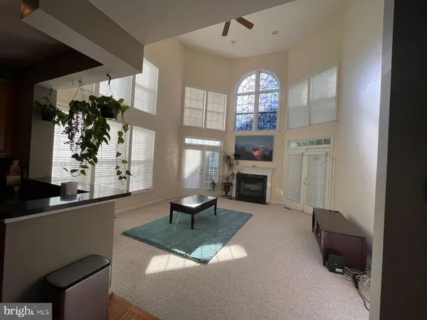 a living room with furniture a fireplace and a window