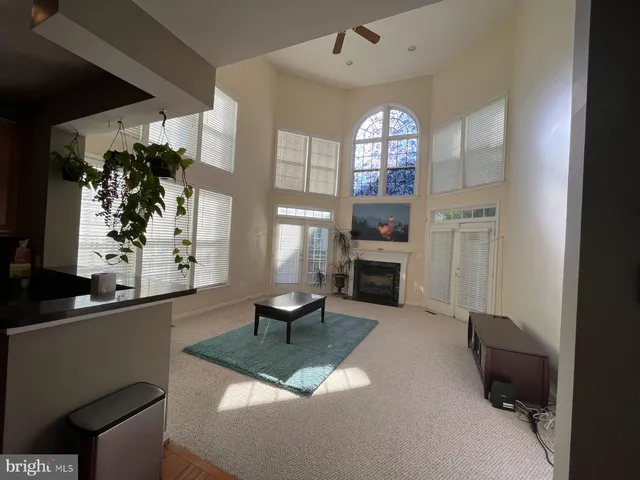 a living room with furniture a fireplace and a window