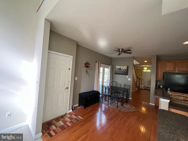 a living room with furniture a flat screen tv and a chandelier