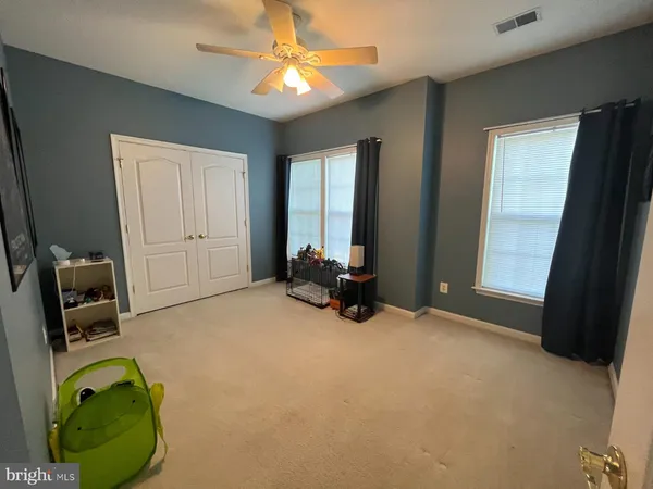 a view of a room with gym equipment and a large window