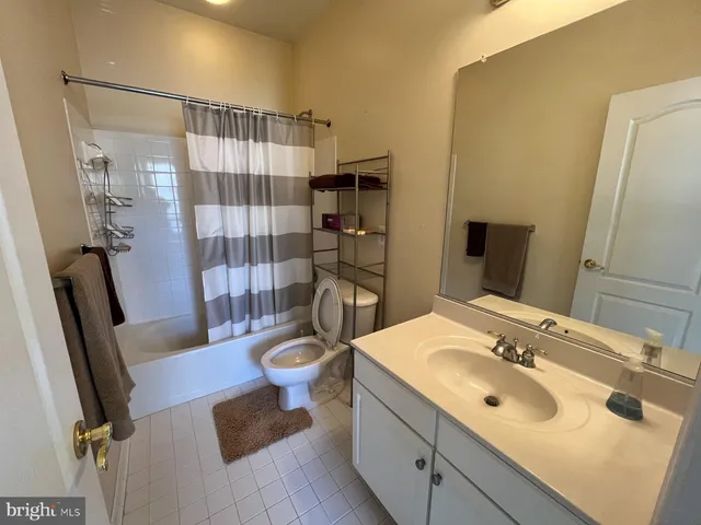 a bathroom with a sink a toilet a shower and a mirror