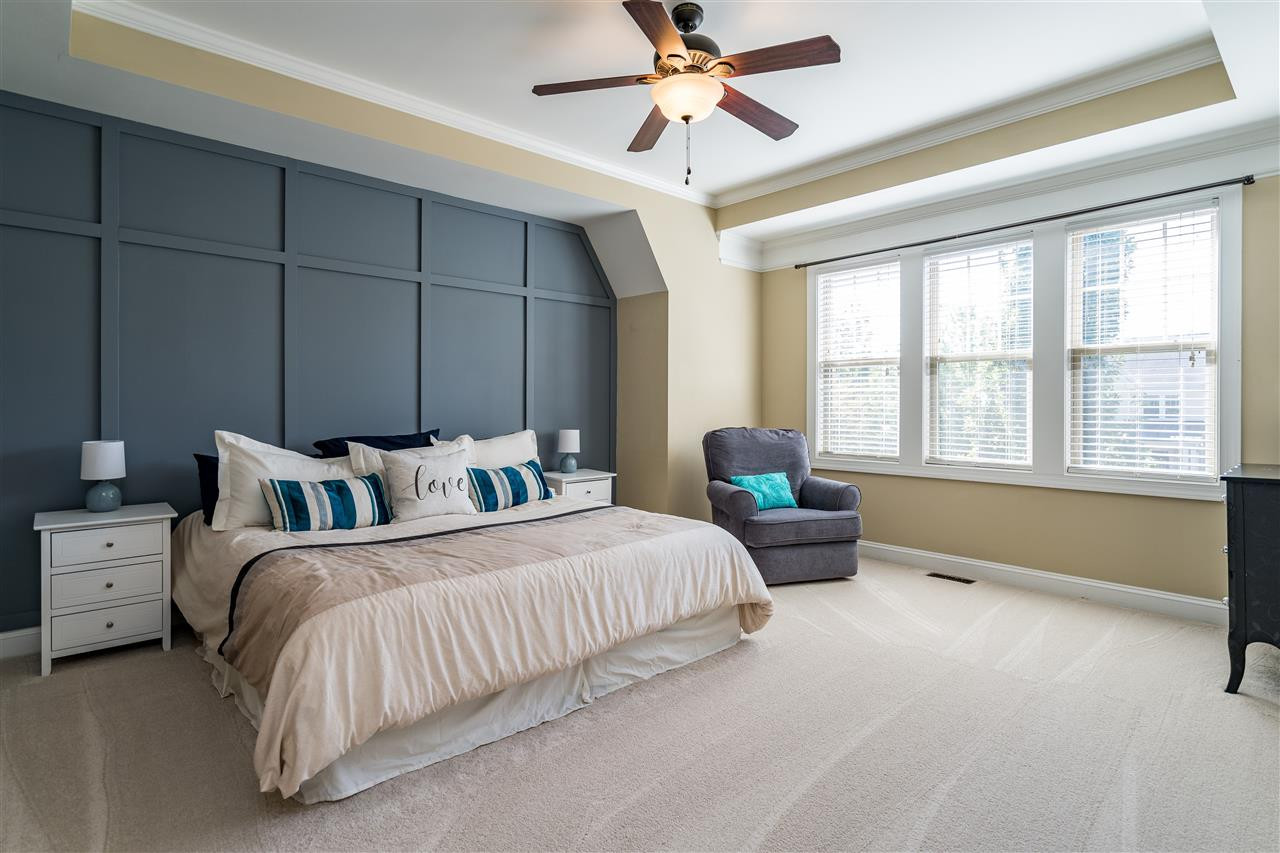 1411 Van Page Boulevard Raleigh, NC 27607 - Photo 17 of 26 Owner's suite features custom trim work feature wall, new, plush upgraded plush carpet, tray ceiling, ceiling fan and long hallway to two separate closets. Owner's Suite