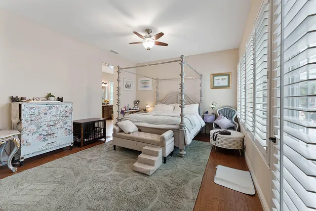 a kitchen with stainless steel appliances granite countertop a refrigerator a sink dishwasher and wooden cabinets with wooden floor