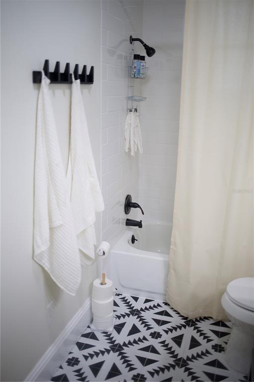 1126 Ruby Street Lakeland, FL 33815 - Photo 27 of 38 a bathroom with a sink a toilet and shower