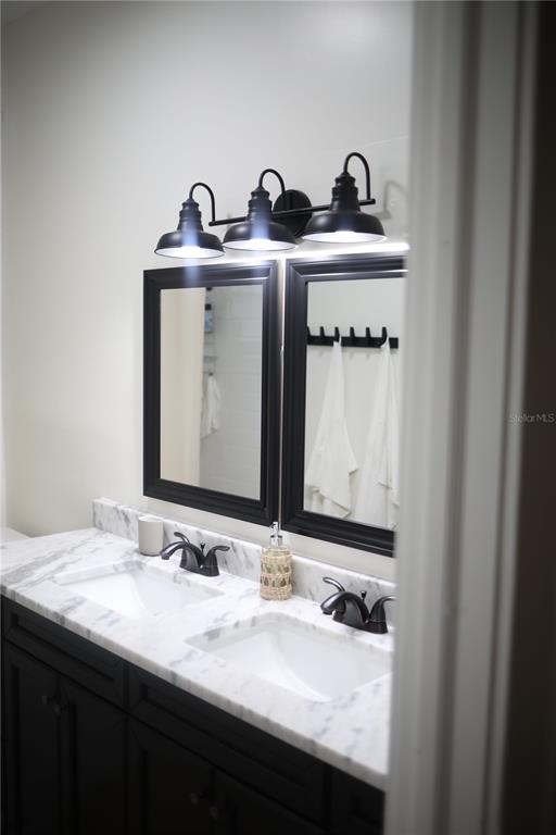 1126 Ruby Street Lakeland, FL 33815 - Photo 29 of 38 a bathroom with a sink and a mirror