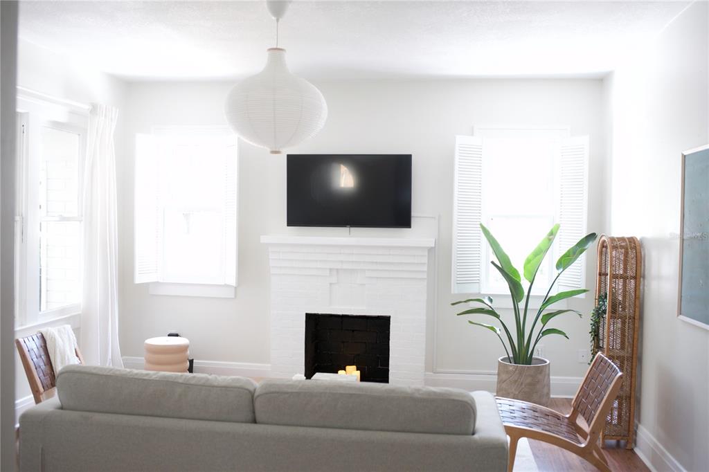 1126 Ruby Street Lakeland, FL 33815 - Photo 6 of 38 a living room with furniture a fireplace and a flat screen tv