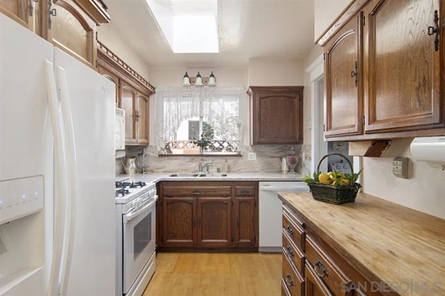 a kitchen with stainless steel appliances granite countertop a sink and cabinets