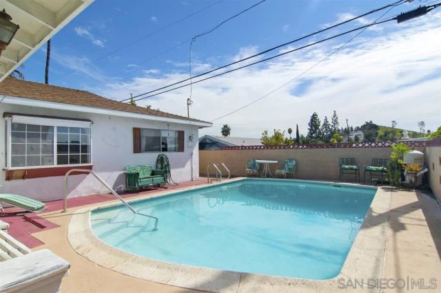 a view of a house with swimming pool and sitting area