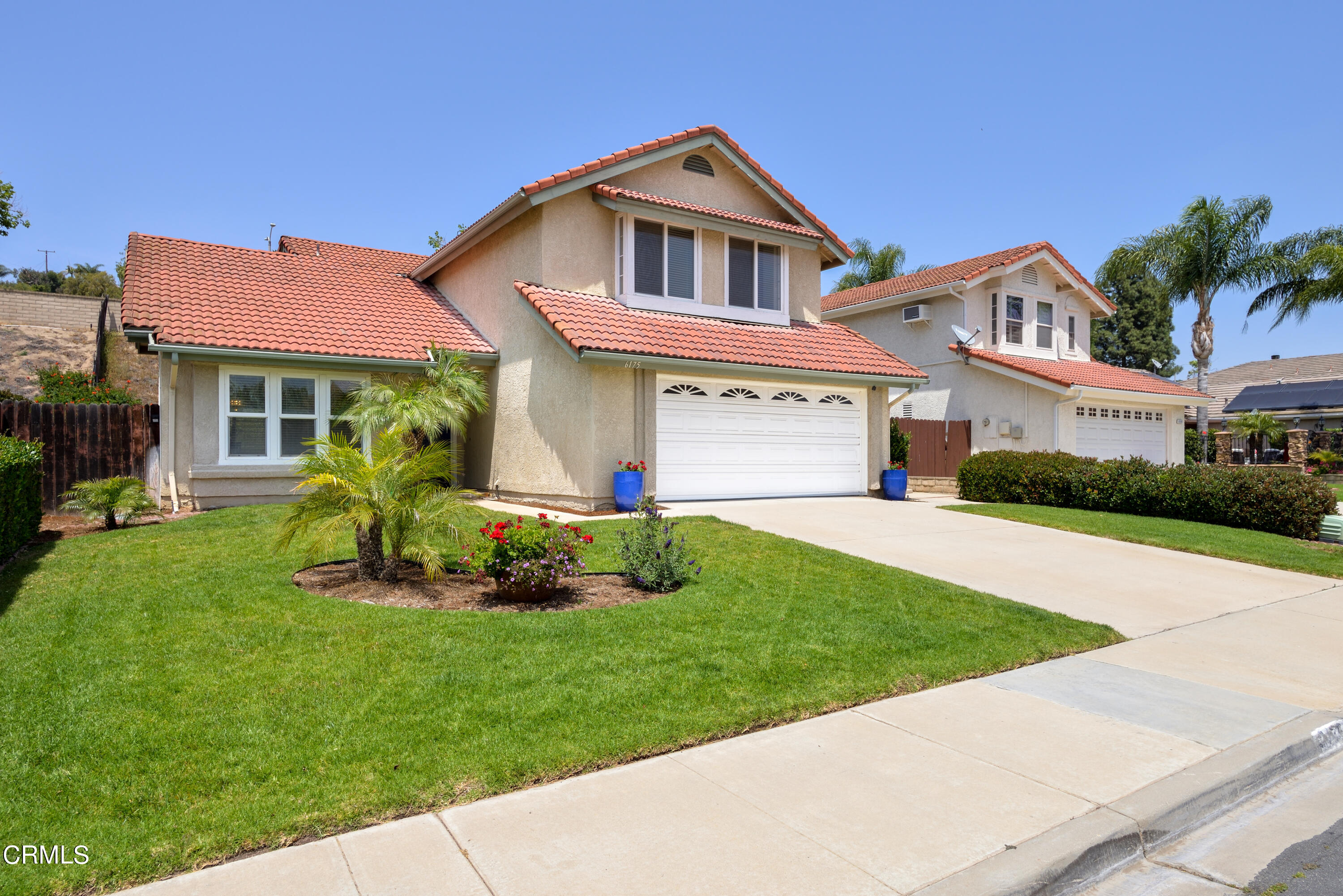 6175 Palomar Circle Camarillo, CA 93012 - Photo 25 of 25 a front view of a house with a garden and plants