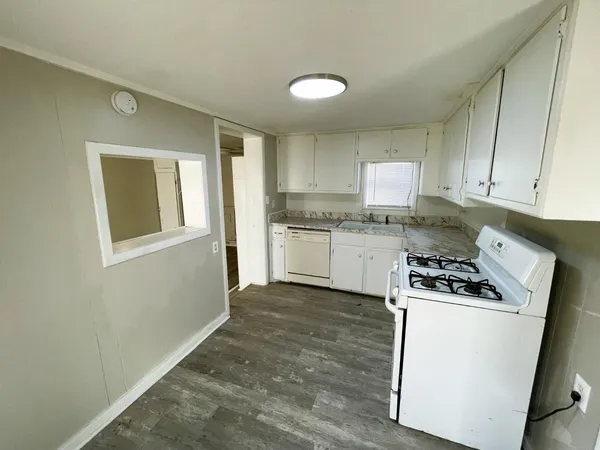 a kitchen with a stove a sink and a refrigerator