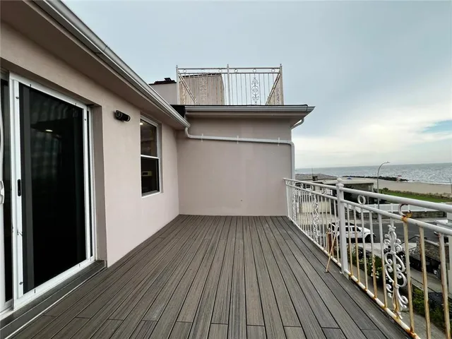 a view of a balcony with wooden floor
