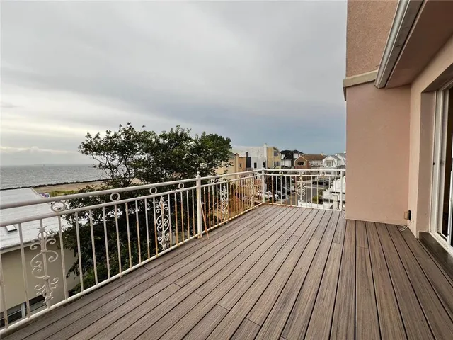 a view of balcony with wooden floor