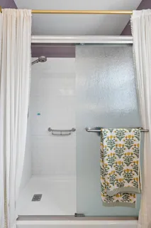 a bathroom with a glass shower door