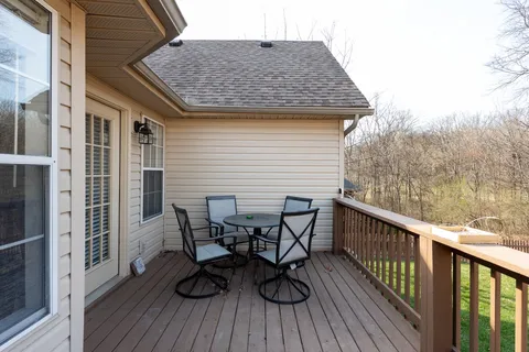 a view of balcony with furniture and wooden floor