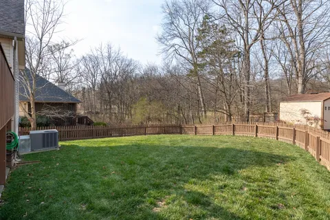 a view of a backyard with large trees