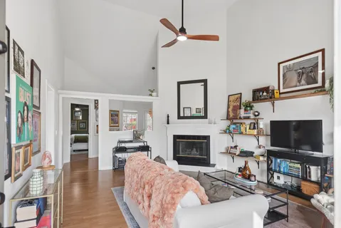 a living room with furniture a flat screen tv and a fireplace