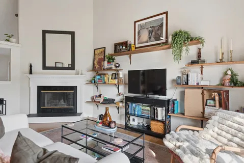 a living room with furniture a fireplace and a flat screen tv